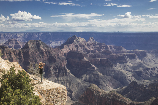 overcoming fear of heights. hiker on high cliff edge of grand canyon natiional park